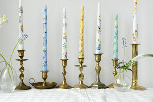row of hand painted candles with festive designs