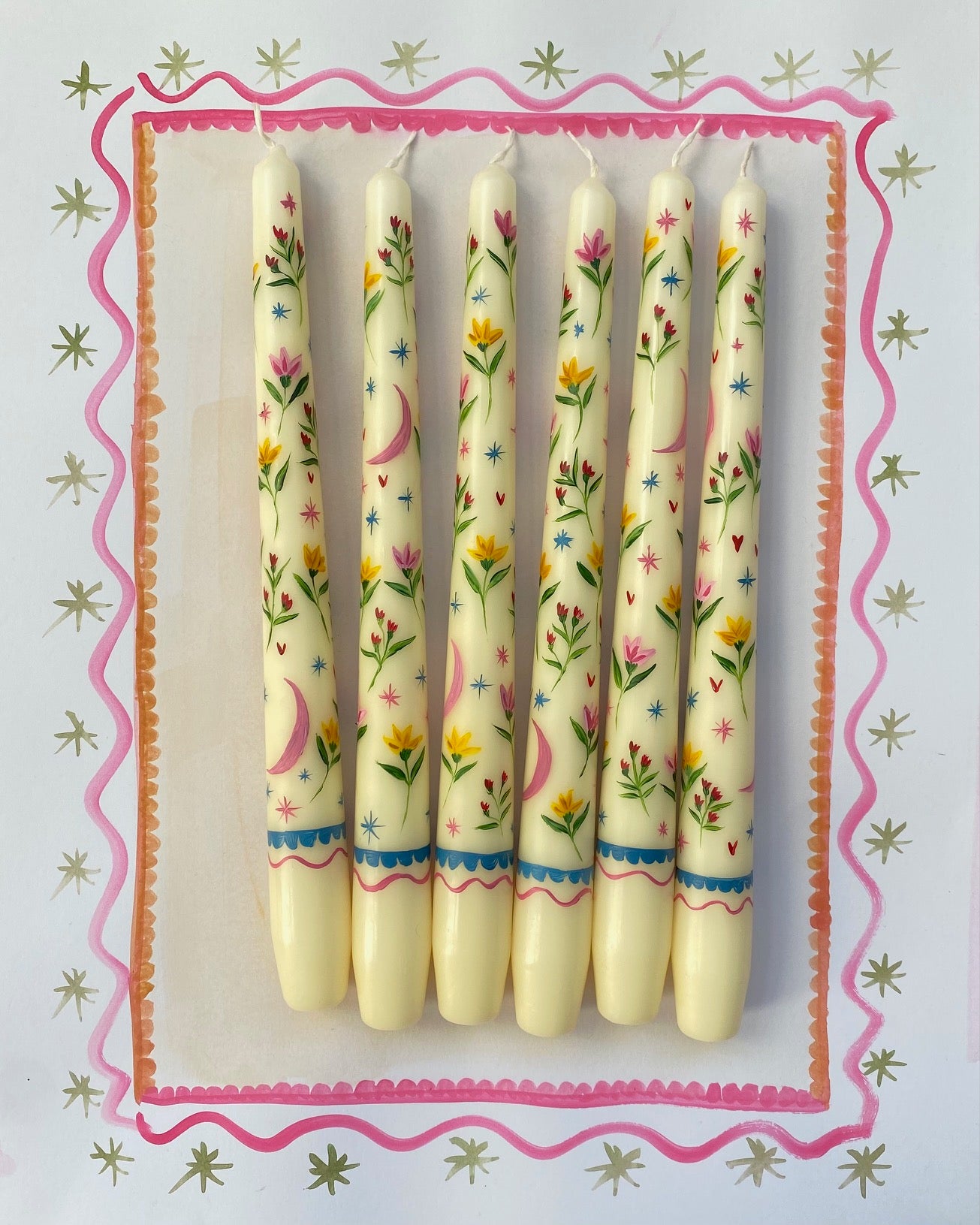 ivory dinner candles with celestial and floral hand painted details.