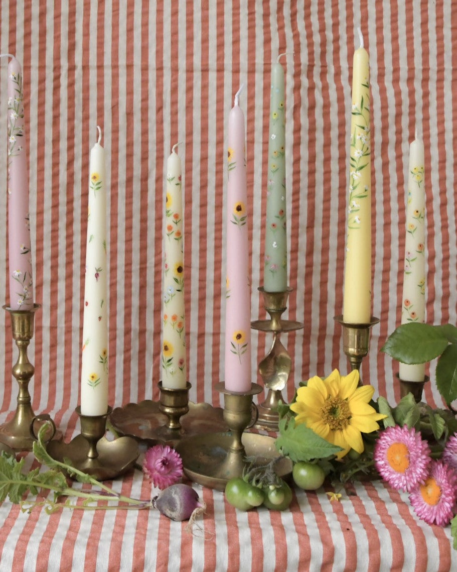 pink dinner candles are hand painted with yellow sunflowers