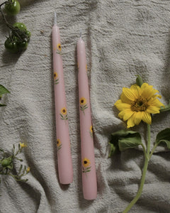 pink dinner candles are hand painted with yellow sunflowers