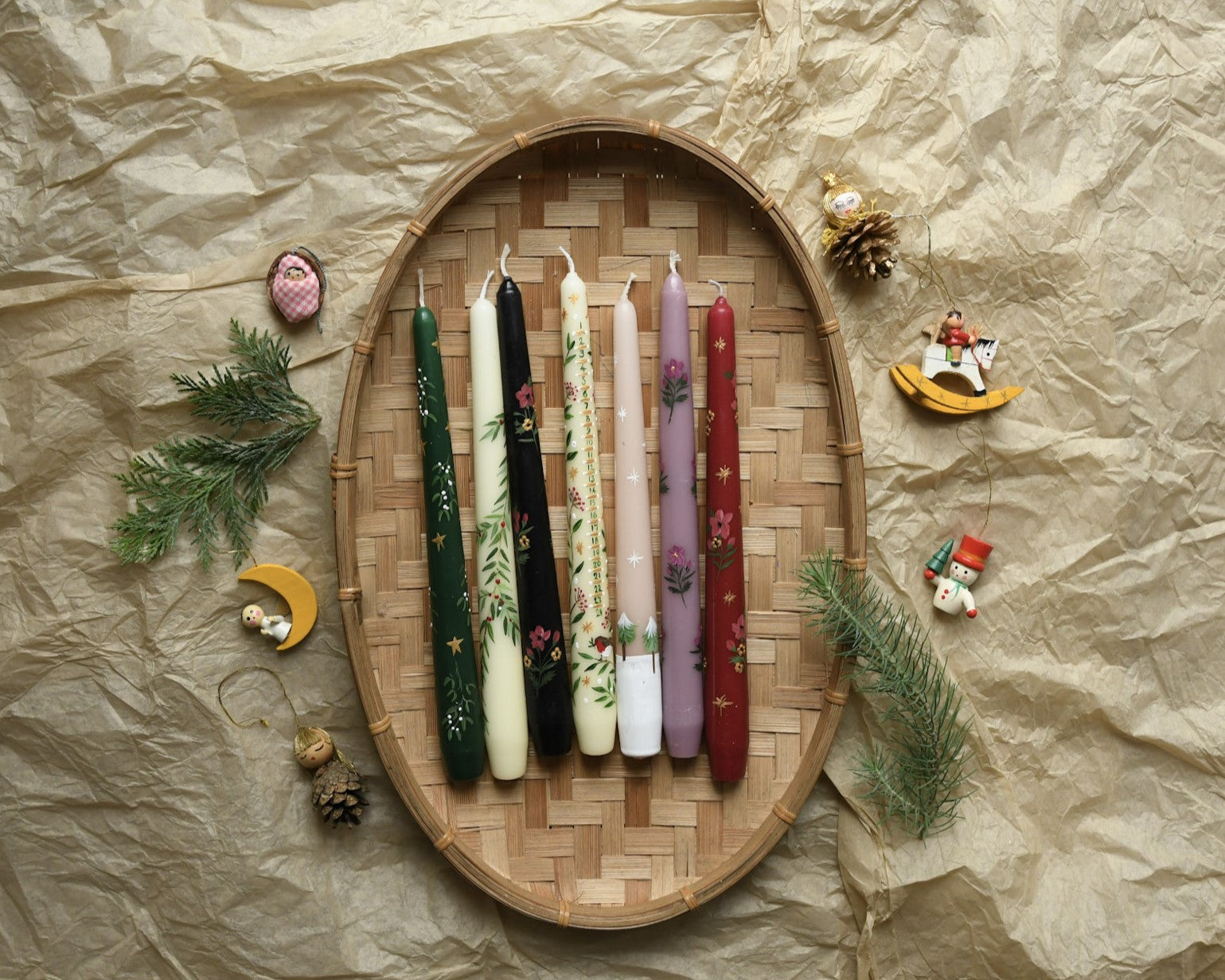 hand painted christmas candles in a basket