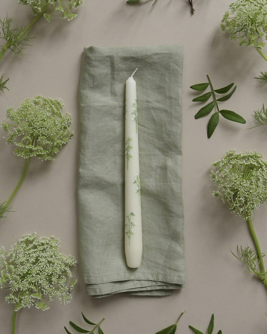 ivory dinner candle is painted with delicate cow parsley design.
