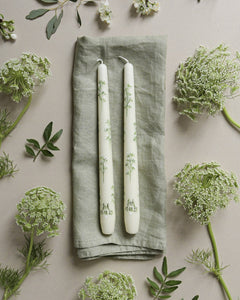 ivory dinner candle is painted with delicate cow parsley design and includes personalised initials on the candles.